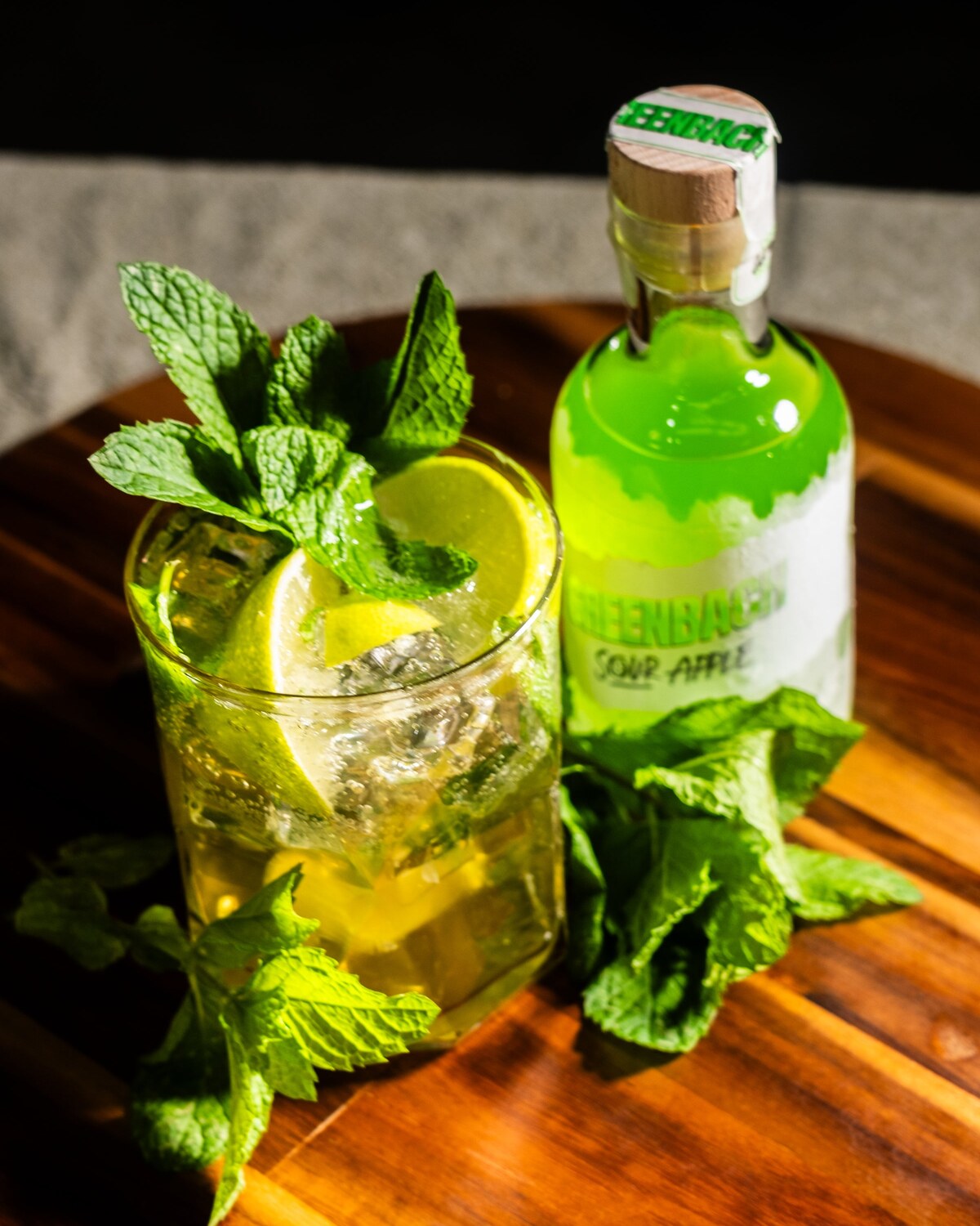 The GBM over ice with mint and lemon on a timber board