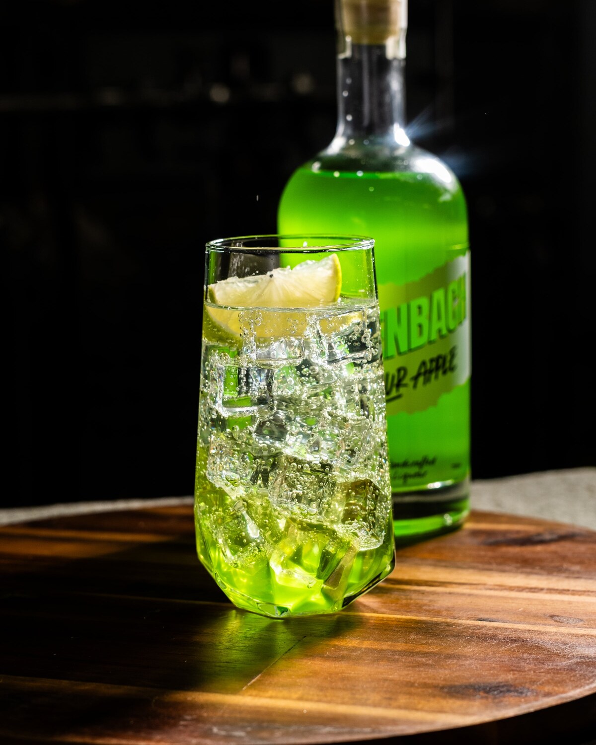 A Greenbach seltzer in a highball, ice to the top